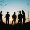 Silhouette of teenagers in a field