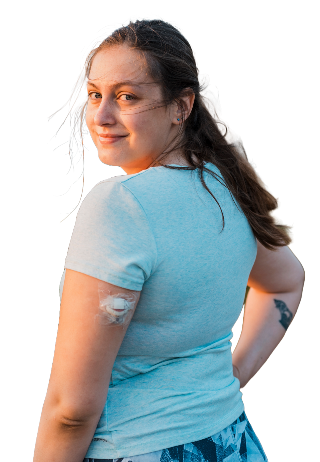 Smiling woman with diabetes monitor patch on arm